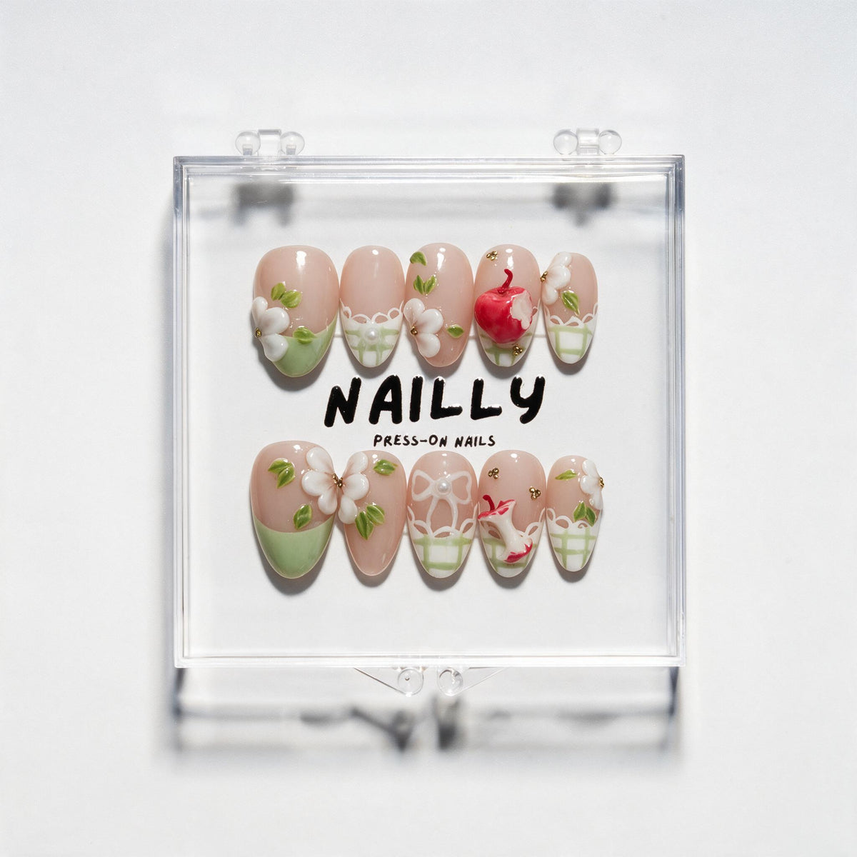 Picnic short almond press-on nails in blush pink and pale green with gingham details, white accents and a bitten red apple