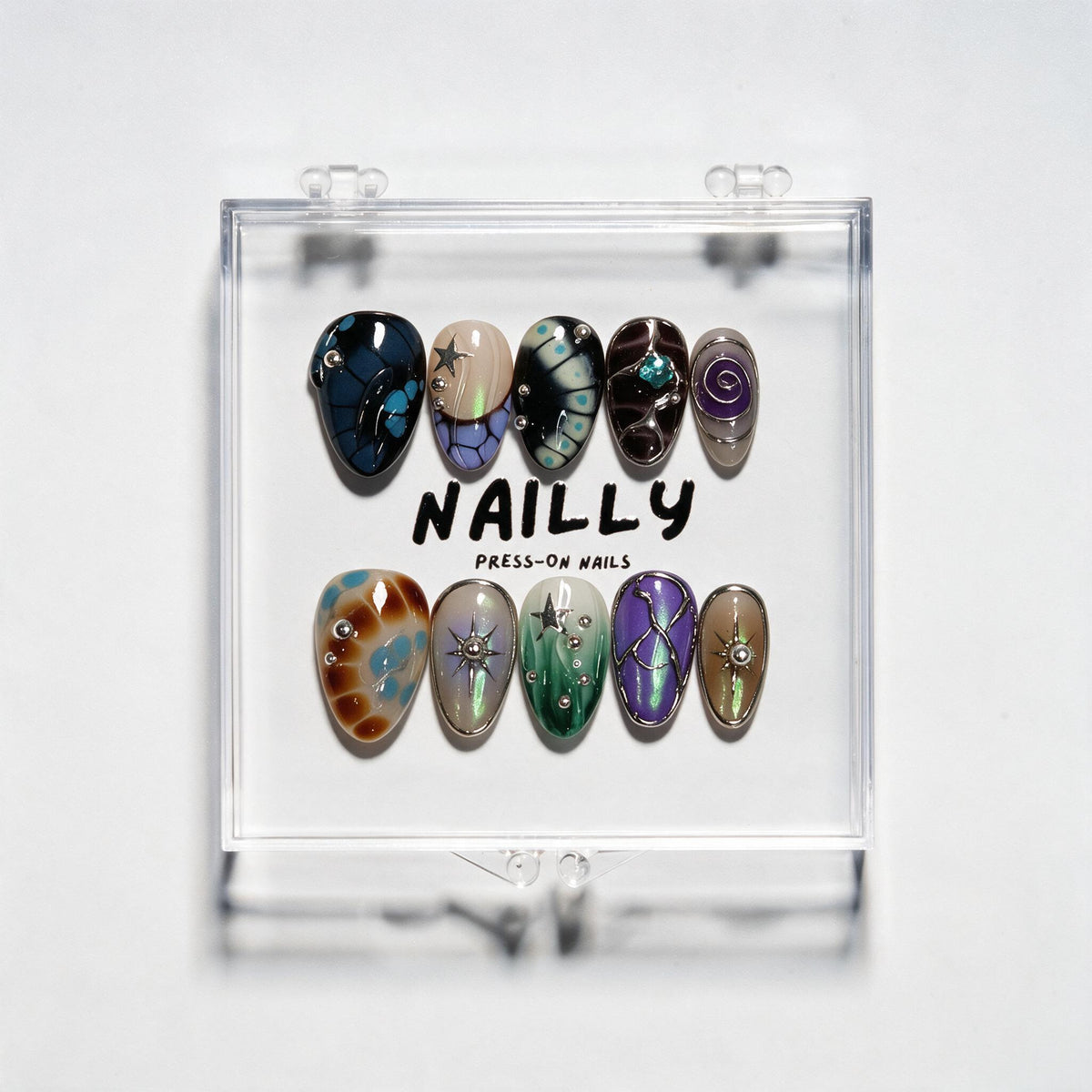 Reborn short almond press-on nails in navy, teal, green and purple with iridescent wing-like patterns, silver studs and crystal detail