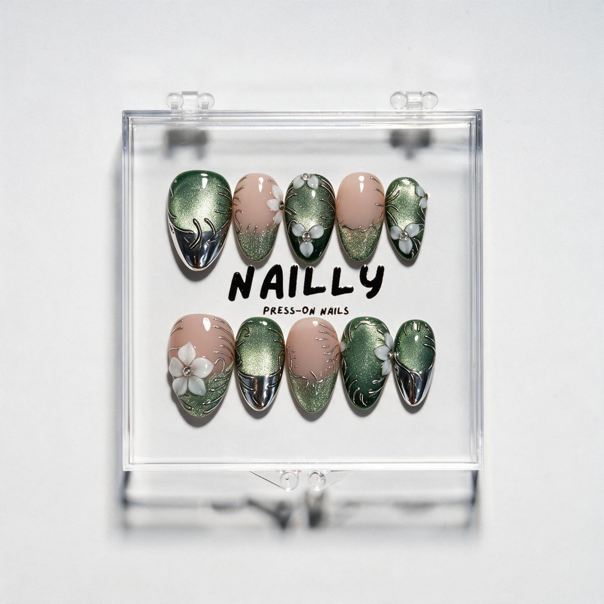 The Ferns short almond press-on nails in forest green and blush nude with silver chrome, white petals and crystal details