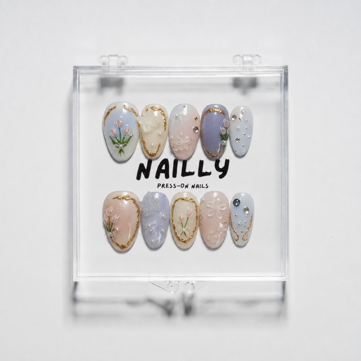 Versailles short almond press-on nails in pastel blue, blush pink, lavender and ivory with tulip, gold, pearl and rhinestone details